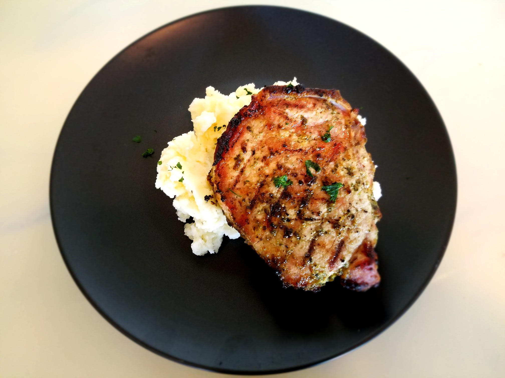 Sunday Gravy with yeah right: Football is on the Horizon! Grilled Pesto Pork Chops and Roasted Garlic Mashed Potatoes.